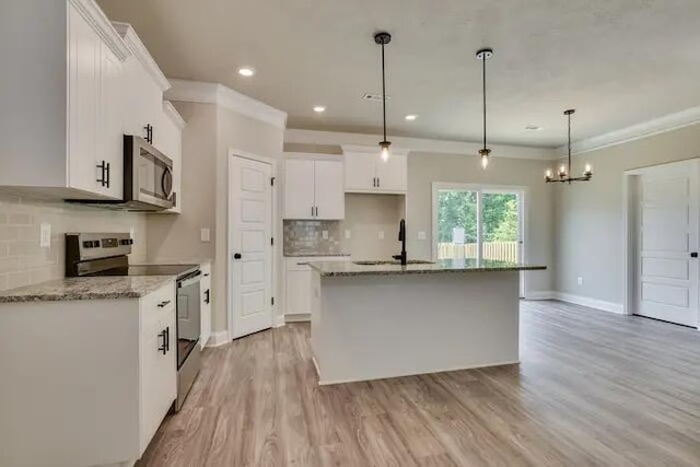 1068 Burlington Dr, Augusta, GA 30909 - kitchen featuring appliances with stainless steel finishes, a sink, backsplash, a chandelier, and light stone counters