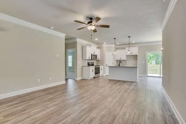 1068 Burlington Dr, Augusta, GA 30909 - unfurnished living room featuring crown molding, baseboards, light wood-style flooring, recessed lighting, and a sink