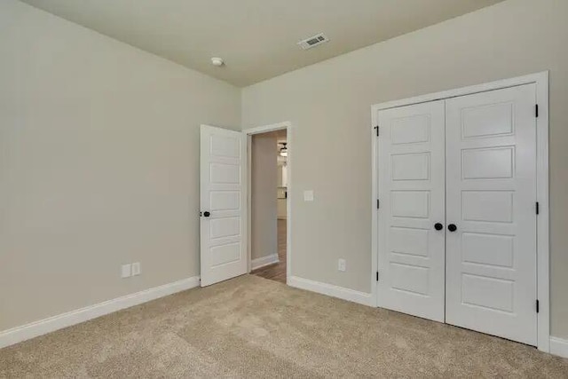 1068 Burlington Dr, Augusta, GA 30909 - unfurnished bedroom featuring light colored carpet, baseboards, and a closet