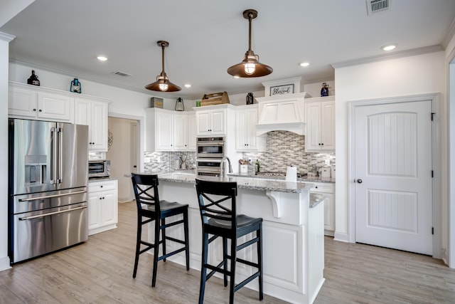 210 Rivernorth Dr, North Augusta, SC 29841 - kitchen featuring stainless steel appliances, decorative backsplash, crown molding, white cabinetry, and custom range hood