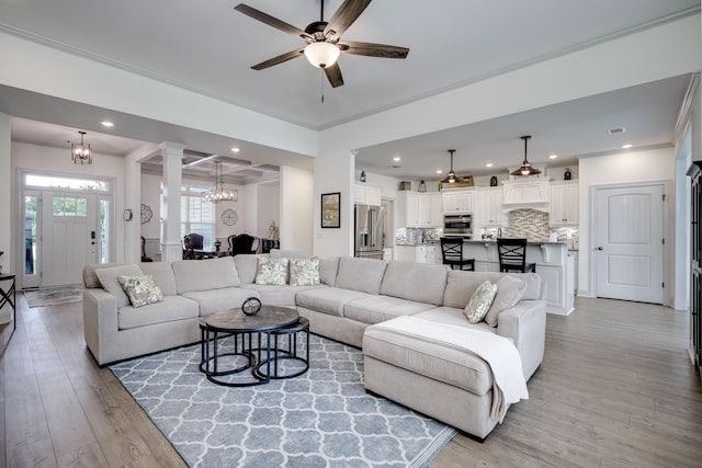 210 Rivernorth Dr, North Augusta, SC 29841 - living area featuring light wood finished floors, a chandelier, a ceiling fan, decorative columns, and recessed lighting
