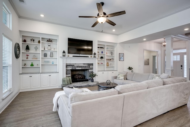 210 Rivernorth Dr, North Augusta, SC 29841 - living room featuring light wood-style flooring, a stone fireplace, ceiling fan, built in shelves, and recessed lighting