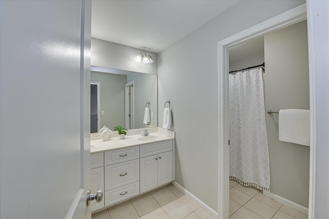 1132 Sumter Landing Cir, Evans, GA 30809 - bathroom featuring double vanity, tile patterned flooring, baseboards, and a shower with shower curtain