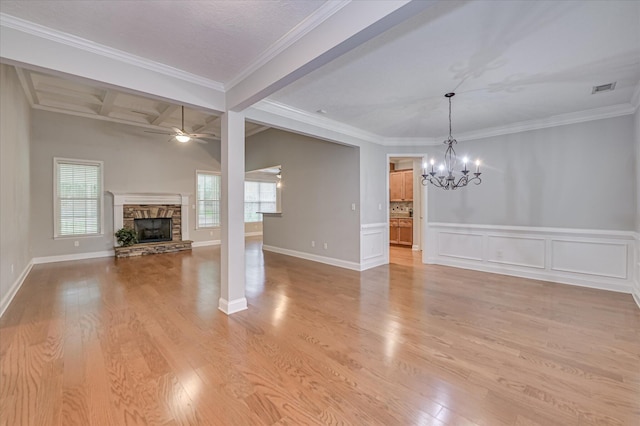 1132 Sumter Landing Cir, Evans, GA 30809 - unfurnished living room with a chandelier, a stone fireplace, a ceiling fan, light wood-style floors, and beam ceiling