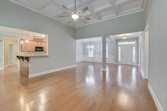 1132 Sumter Landing Cir, Evans, GA 30809 - unfurnished living room with crown molding, light wood-type flooring, beam ceiling, coffered ceiling, and ceiling fan