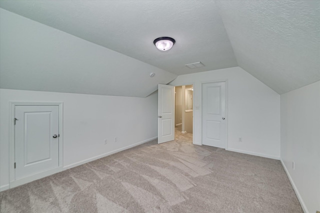1132 Sumter Landing Cir, Evans, GA 30809 - bonus room with carpet floors, lofted ceiling, baseboards, and a textured ceiling