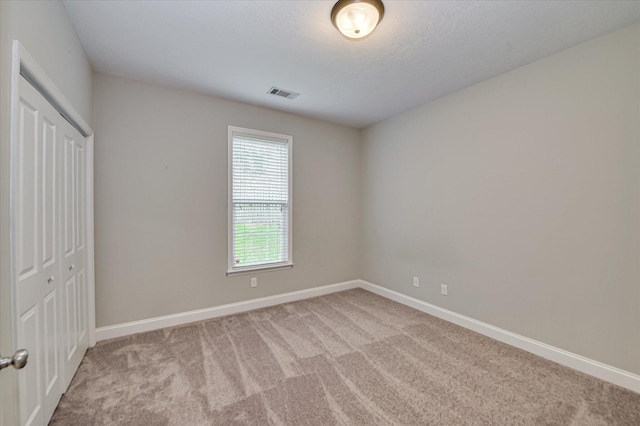 1132 Sumter Landing Cir, Evans, GA 30809 - unfurnished bedroom with light carpet, baseboards, and a closet