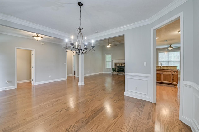 1132 Sumter Landing Cir, Evans, GA 30809 - unfurnished dining area featuring ceiling fan, healthy amount of natural light, light wood-style floors, ornamental molding, and a wainscoted wall