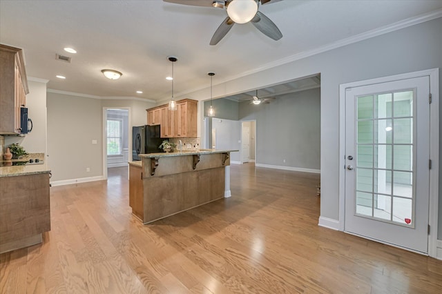 1132 Sumter Landing Cir, Evans, GA 30809 - kitchen with a ceiling fan, black appliances, baseboards, a breakfast bar area, and ornamental molding