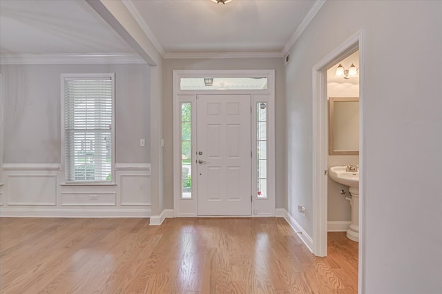 1132 Sumter Landing Cir, Evans, GA 30809 - foyer entrance featuring light wood-style flooring, ornamental molding, and a wainscoted wall