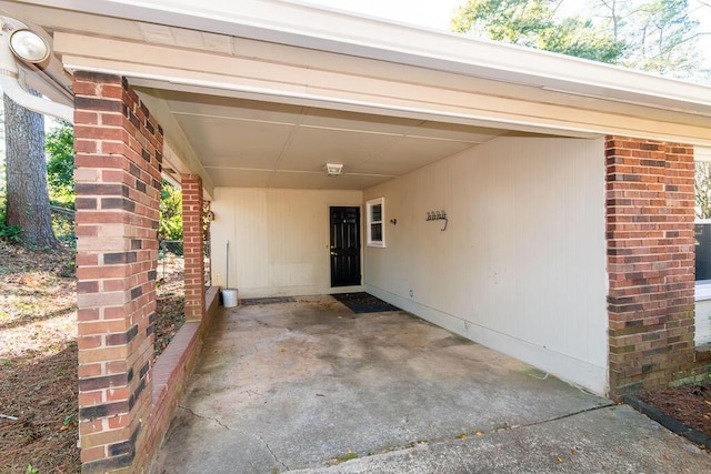 doorway to property featuring a carport