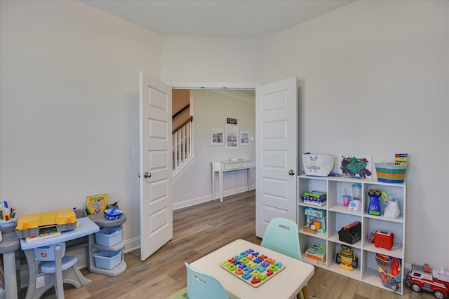 rec room featuring baseboards and wood finished floors