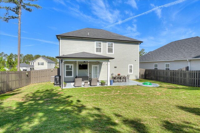 back of house with a yard, a patio, ceiling fan, and a fenced backyard