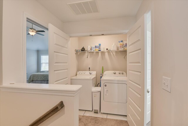 laundry room featuring laundry area, ceiling fan, separate washer and dryer, light tile patterned floors, and visible vents