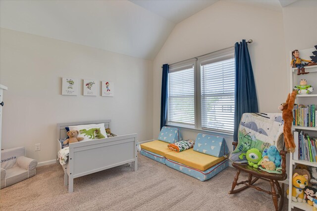 carpeted bedroom with baseboards and lofted ceiling