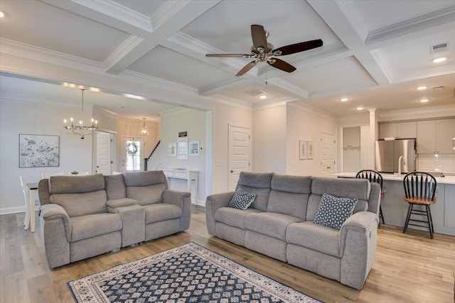 living room featuring crown molding, coffered ceiling, light wood-type flooring, and beam ceiling