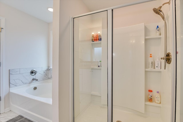 full bathroom featuring a shower stall and a bath