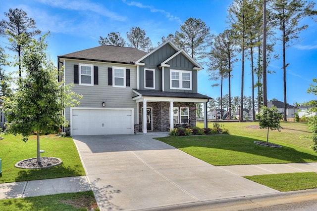 craftsman inspired home with board and batten siding, covered porch, a garage, a front lawn, and concrete driveway