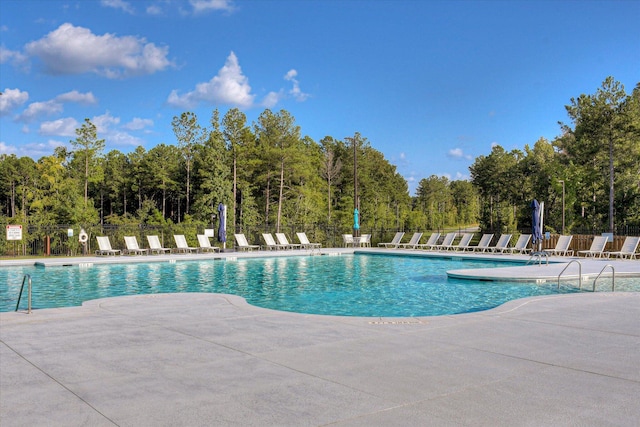 pool featuring a patio and fence