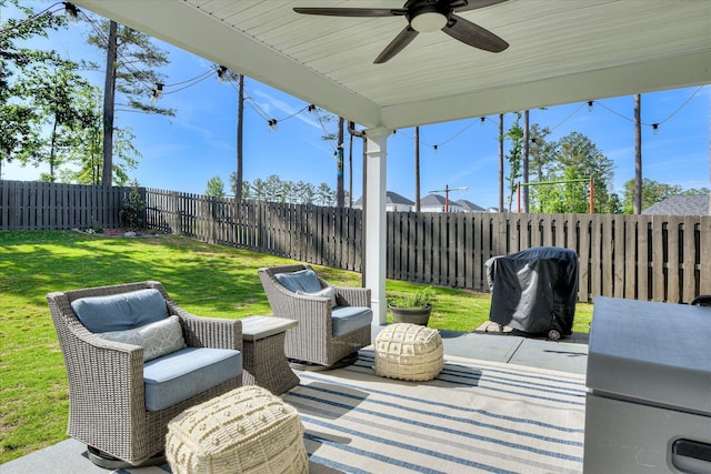 view of patio with grilling area, a ceiling fan, and a fenced backyard