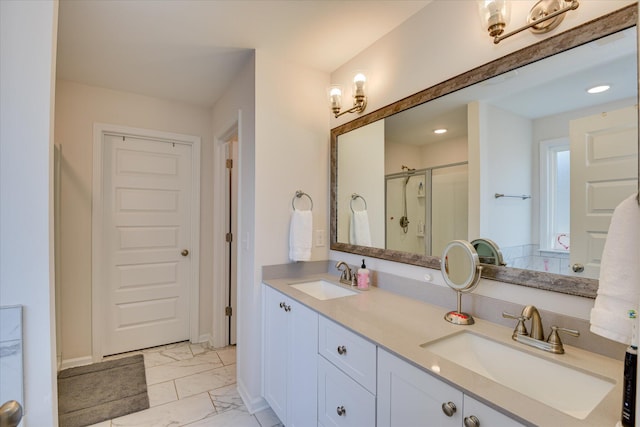 full bath featuring a sink, a stall shower, double vanity, and marble finish floor