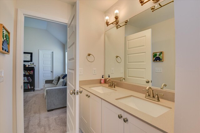 full bathroom featuring double vanity, vaulted ceiling, a sink, and an inviting chandelier