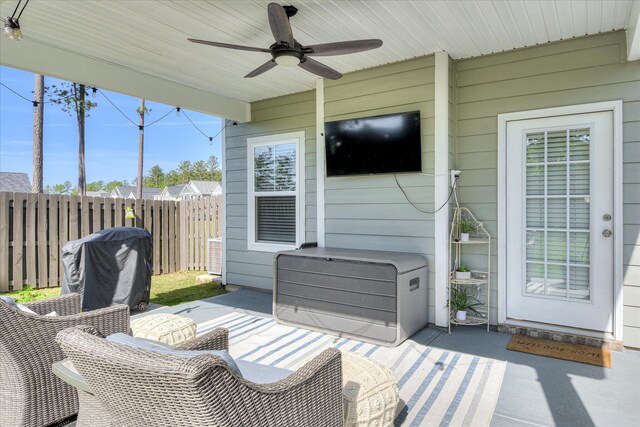 view of patio featuring fence and a ceiling fan