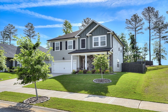 view of front of property featuring board and batten siding, driveway, a front yard, a garage, and fence