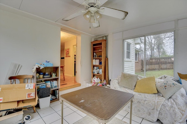 tiled living room featuring ceiling fan