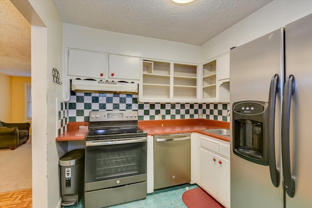 kitchen featuring white cabinetry, tasteful backsplash, stainless steel appliances, and a textured ceiling