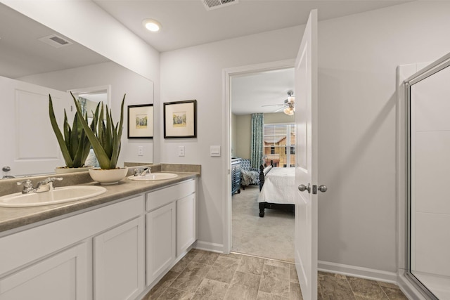 bathroom featuring ceiling fan, walk in shower, and vanity