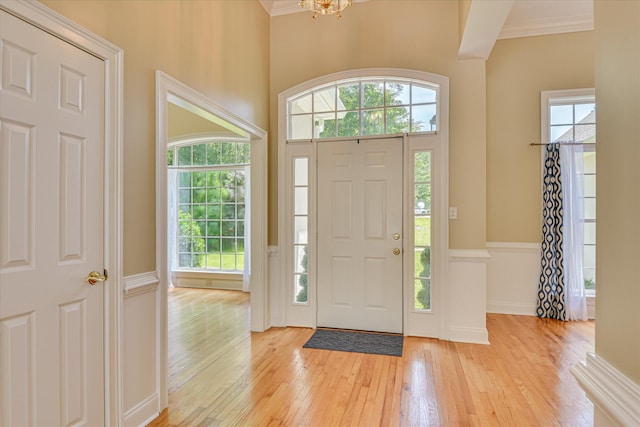 327 Peter Carnes Dr, North Augusta, SC 29860 - entryway with light wood-type flooring, healthy amount of natural light, ornamental molding, and a chandelier