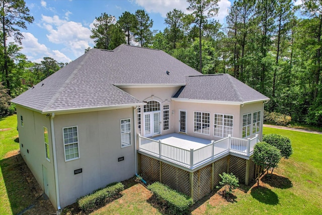 327 Peter Carnes Dr, North Augusta, SC 29860 - rear view of house featuring stucco siding, a lawn, roof with shingles, and a deck