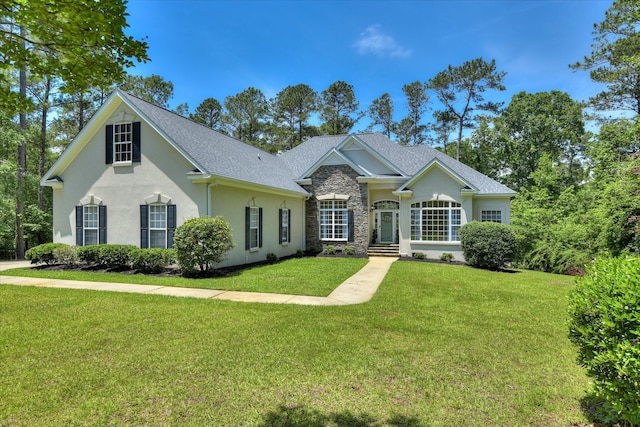 327 Peter Carnes Dr, North Augusta, SC 29860 - view of front facade featuring stone siding, a front yard, stucco siding, and a shingled roof