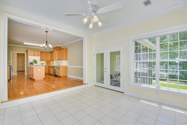 327 Peter Carnes Dr, North Augusta, SC 29860 - kitchen with plenty of natural light, stainless steel appliances, a chandelier, light countertops, and ornamental molding