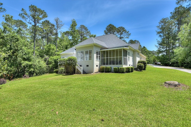 327 Peter Carnes Dr, North Augusta, SC 29860 - view of side of property featuring a sunroom, a yard, driveway, a shingled roof, and stucco siding