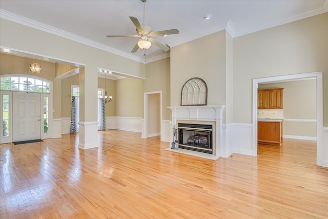 327 Peter Carnes Dr, North Augusta, SC 29860 - unfurnished living room with a chandelier, light wood-style floors, a fireplace with flush hearth, crown molding, and a ceiling fan