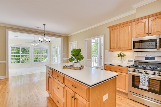 327 Peter Carnes Dr, North Augusta, SC 29860 - kitchen featuring stainless steel appliances, a chandelier, a kitchen island, tasteful backsplash, and light wood finished floors