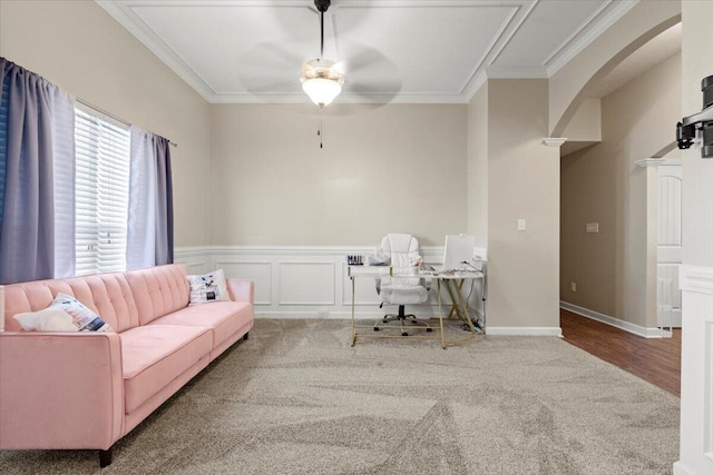 office featuring carpet flooring, ceiling fan, and crown molding