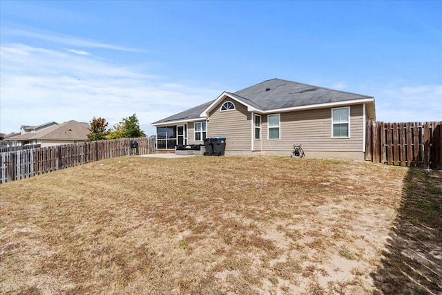 back of house with a lawn