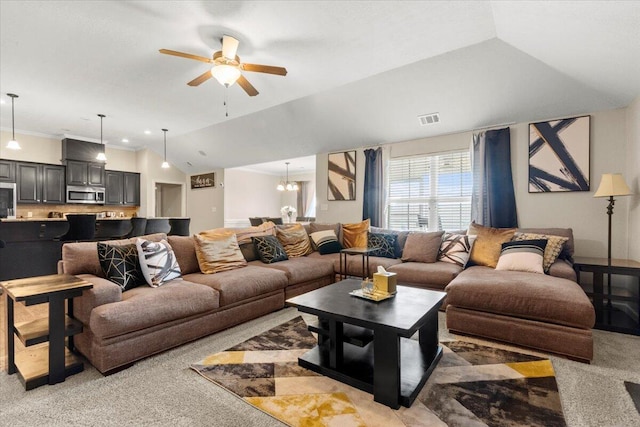 carpeted living room featuring ceiling fan with notable chandelier, vaulted ceiling, and crown molding