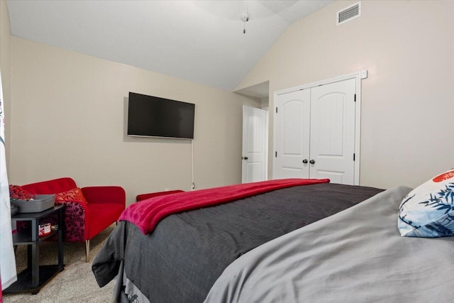 bedroom with carpet floors, a closet, and lofted ceiling