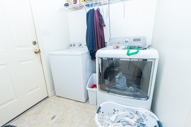 clothes washing area featuring laundry area and washer and clothes dryer