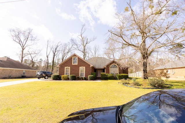 view of front of home featuring a front yard and brick siding