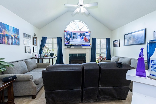 living room with light carpet, high vaulted ceiling, a fireplace, and a ceiling fan