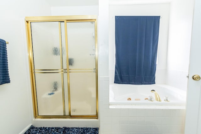 full bath with a jetted tub and a stall shower