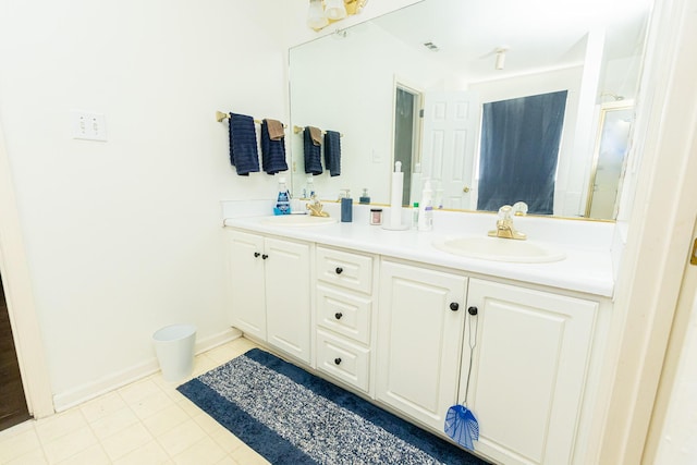 full bath featuring visible vents, a sink, baseboards, and double vanity