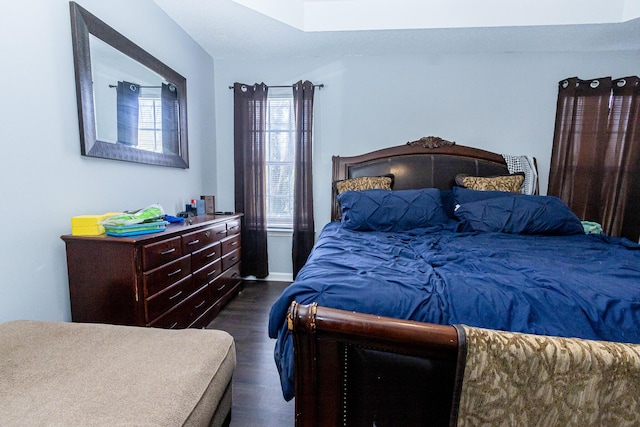 bedroom with dark wood-style floors