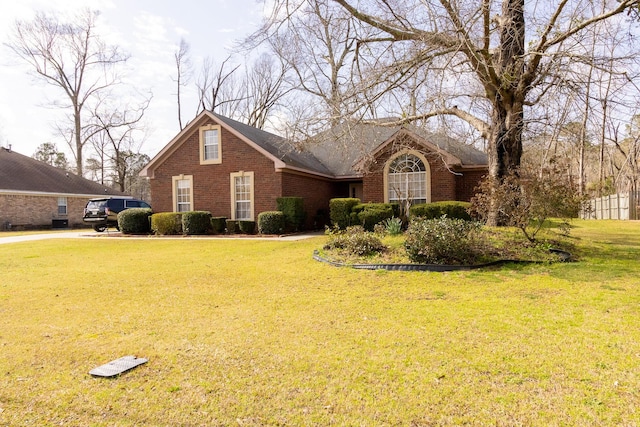 view of front of house with brick siding and a front yard