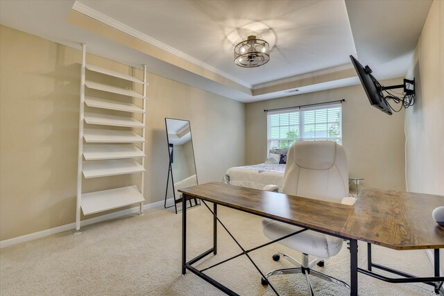 home office with light colored carpet, a raised ceiling, ornamental molding, and baseboards